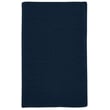 Colonial Mills Courtyard India Ink braided rug in deep blue and beige hues displayed on a hardwood floor setting.
