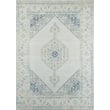 Momeni Isabella ISA-10 Blue rug featuring a detailed floral pattern in shades of blue and cream with a plush texture on a hardwood floor.