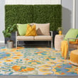Nourison Aloha ALH-22 Ivory, Blue, Yellow rug in a stylish indoor setting, showcasing vibrant floral patterns and cozy ambiance.