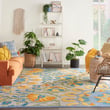 Nourison Aloha ALH-22 rug in ivory, blue, and yellow, displayed in a modern living room setting, showcasing vibrant floral patterns.