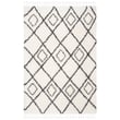 Ivory and dark grey Safavieh Moroccan Tassel Shag MTS-335 rug on hardwood floor, showcasing plush texture and elegant geometric pattern.