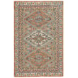 Hand-tufted Capel Shakta Kazak rug in blue, terracotta, and tan, displaying a vibrant geometric pattern on a wooden floor setting.