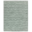 Jaipur Living Fletcher Arcus Seafoam Green rug, handwoven with a subtle pattern, adding elegance and calmness to the living space.