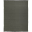 Feizy Rugs Tito TTO0826F in green, handwoven with intricate patterns, displayed in a modern living room with natural lighting.
