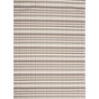 Chilewich Woven Heddle Pebble 005 rug with a textured stone-inspired pattern in neutral tones on a smooth wooden floor setting.