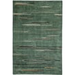 Nanimarquina Colorado Moss rug featuring a hand-knotted construction with a blend of green hues, showcased on a wooden floor setting.