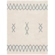 Lorena Canals Atlas Washable rug in natural and vintage blue on a hardwood floor, showcasing its hand-tufted texture and geometric design.