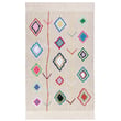Lorena Canals Morocco Kaarol Washable Natural rug in vibrant colors with hand-tufted texture displayed in a cozy, modern living room setting.