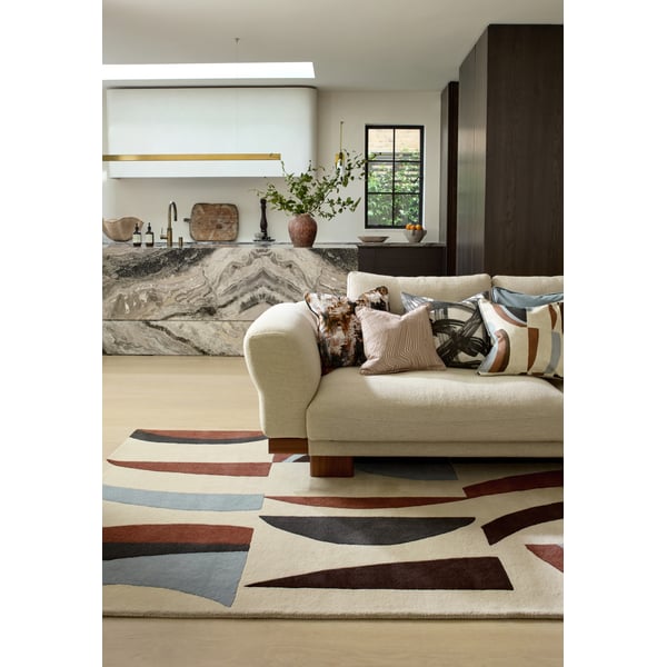 Harlequin for Brink and Campman Torillo Cornflower Walnut rug, featuring hand-tufted design in blue and brown tones on a hardwood floor.